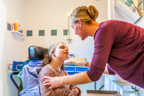 Disability a disabled child being cared for by a nurse / Disabil